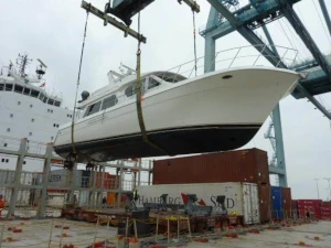 Boat being loaded onto a cradle on a container ship