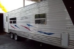 caravan being loaded in a container for shipping to New Zealand